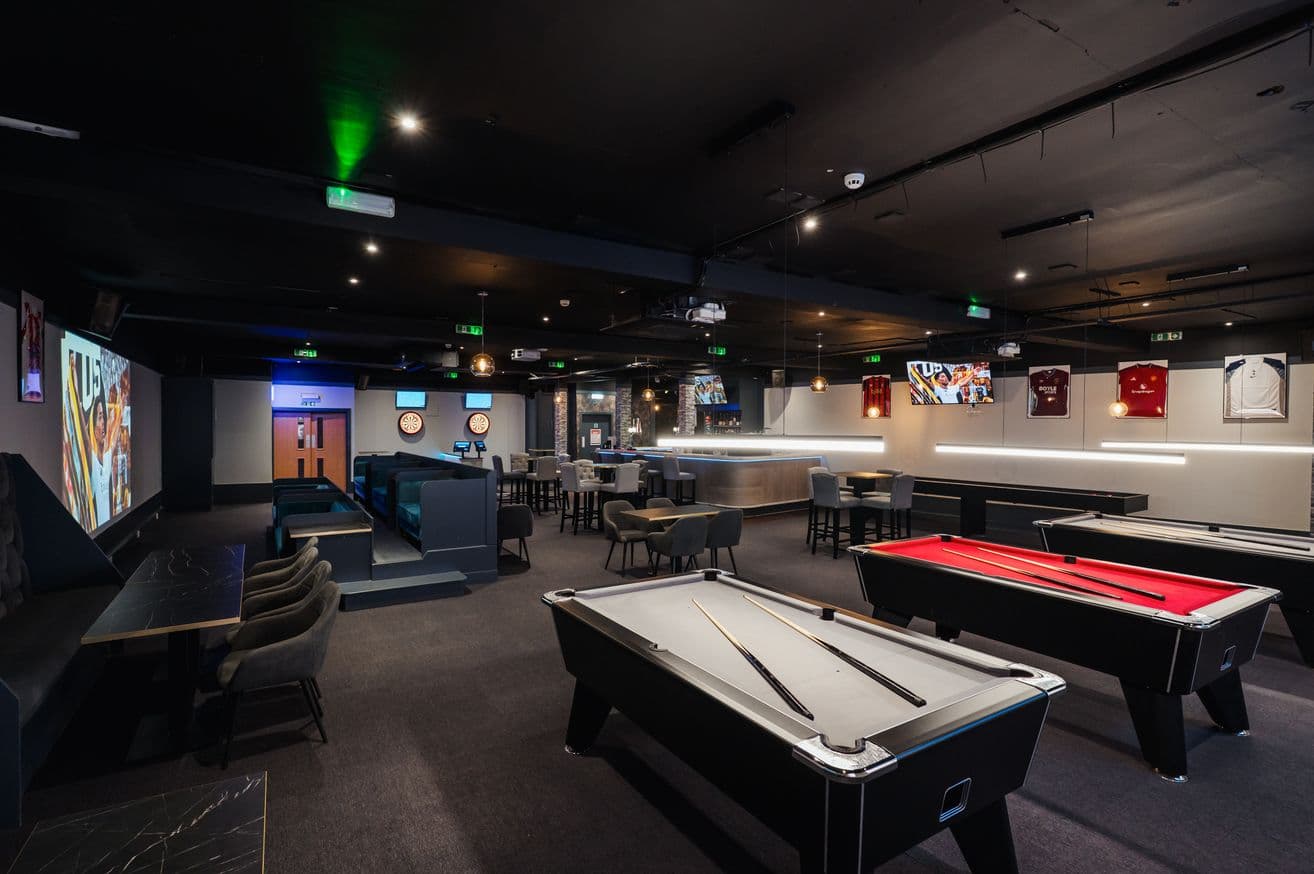 The upstairs bar at DUEL, with pool tables, booths and dartboards